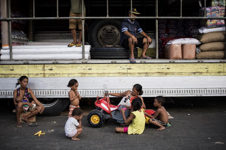 Mothers at Divisoria market in Manila. Photo: AFP Photo/Noel Celis