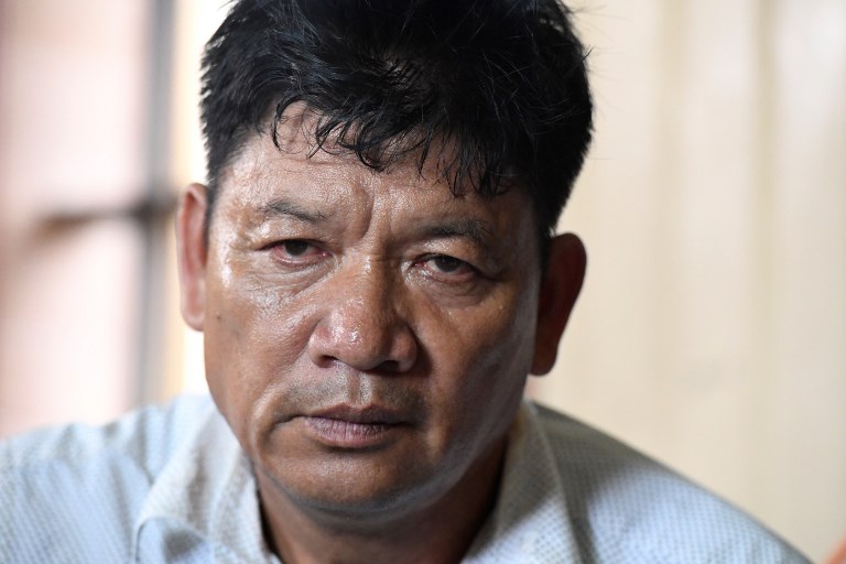 Doan Van Thanh, father of Vietnamese national Doan Thi Huong, is interviewed from his home in Nam Dinh province south of Hanoi on August 16, 2018 while following news on the trial of Huong in Malaysia for her alleged role in the assassination of Kim Jong-Nam, the half-brother of North Korean leader Kim Jong-Un.
A Malaysian court ruled on August 16 the murder trial of two women accused of assassinating the half-brother of North Korea’s leader can proceed — in a blow to their families who insist the pair were tricked into carrying out the dramatic hit.
 / AFP PHOTO / Nhac NGUYEN