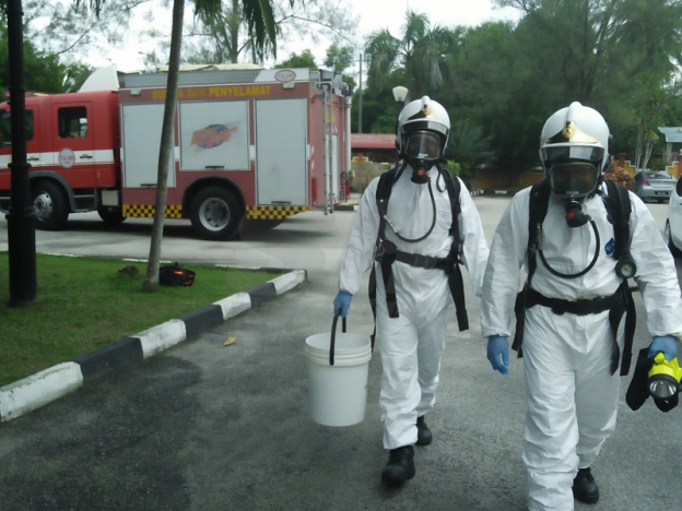 Two workers in Hazmat suits, representational purposes only via Sinar Harian