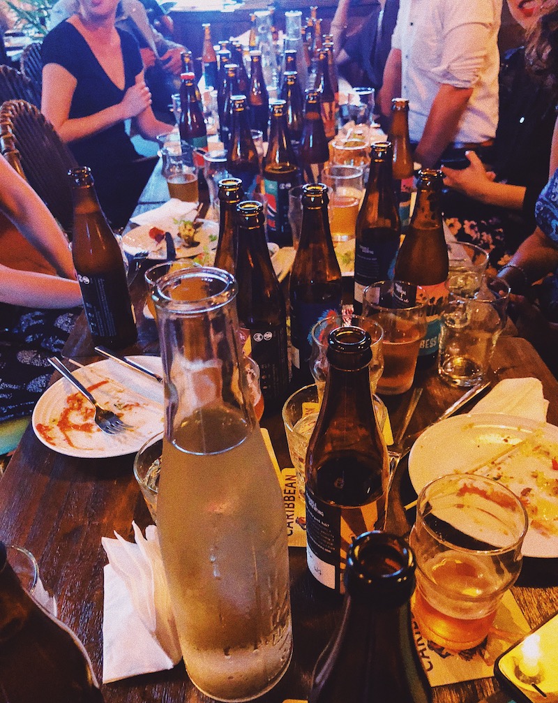 A typical liming sesh with a table full of spent beer bottles. Photo: Coconuts Media