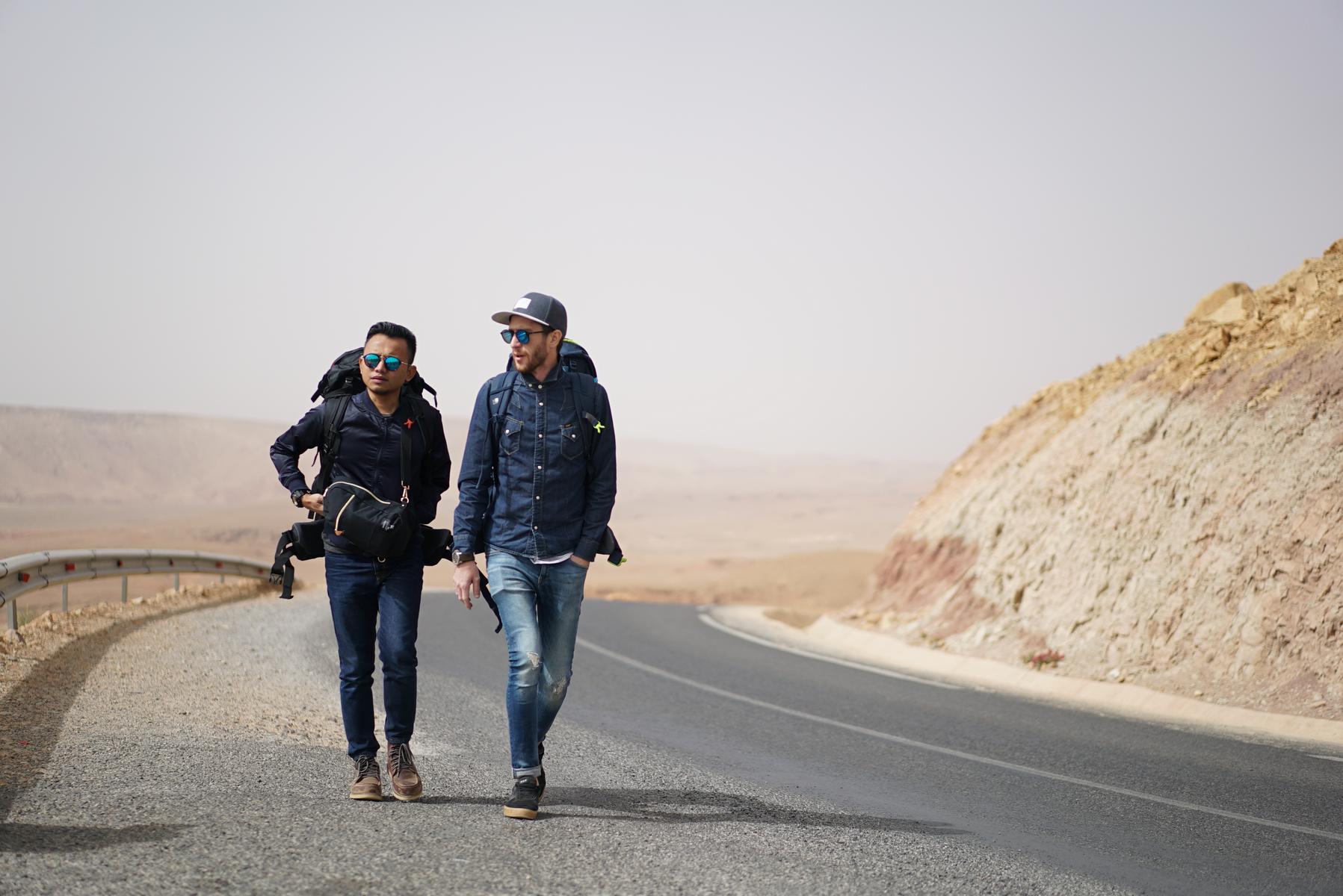 Mat Dan and castmate walk down a road for an episode of “Haramain Backpackers – Trans Siberian.” Photo supplied