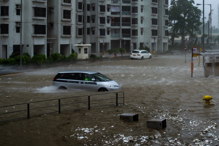 A car tries to navigate in the floods at Heng Fa Chuen during the approach of super Typhoon Mangkhut to Hong Kong on September 16, 2018.
Super Typhoon Mangkhut has smashed through the Philippines, as the biggest storm to hit the region this year claimed the lives of its first victims and forced tens of thousands to flee their homes.  / AFP PHOTO / Philip FONG