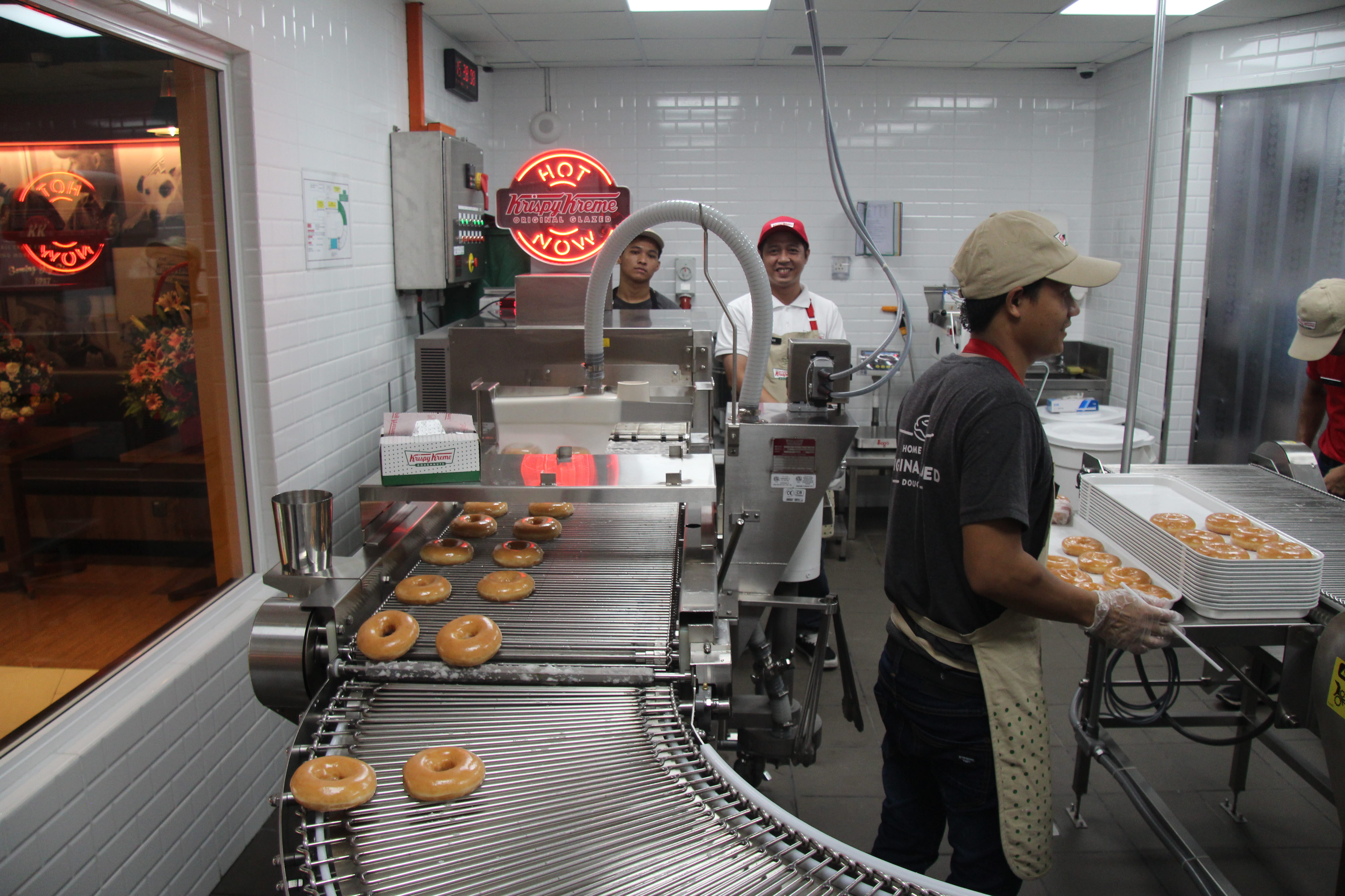 Krispy Kreme staff make fresh glazed donuts at the new Yangon shop. Photo: Coconuts Yangon