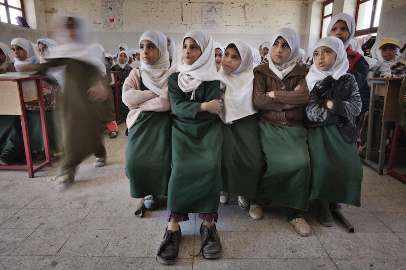 Five Yemeni students sit on one bench at an elementary school in Sanaa, December 2012. The UN Children’s Fund (UNICEF) says access to education is one of the biggest challenges facing children in Yemen today, especially girls. Nearly half of primary school age girls do not go to school. Photo: Laura Boushnak