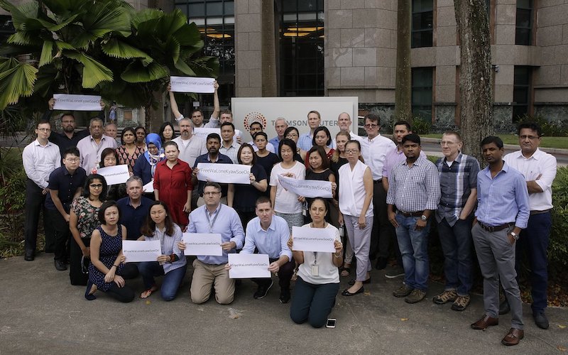 Reuters journalists tweeted a photo of them holding placards outside their headquarters to protest against the jailing of two Myanmar reporters. Photo: Twitter / Aurindom Mukherjee