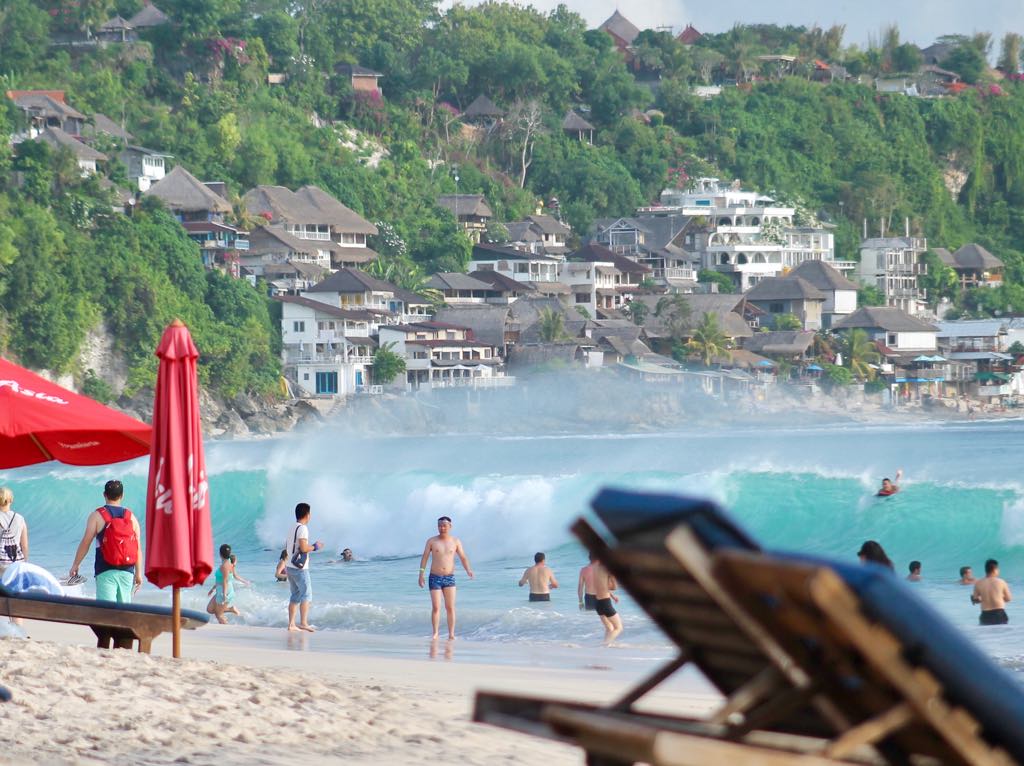 Chinese tourists frolic at Bali’s Dreamland Beach. Photo: Coconuts Bali