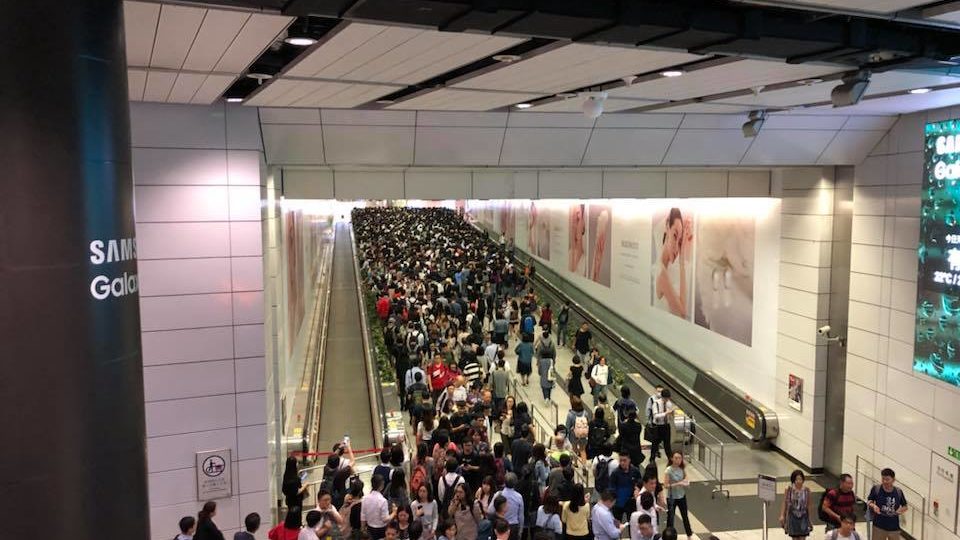 Tens of commuters at Hong Kong station towards Central, which commuters on social media say is now so packed that it’s practically closed. photo via Facebook/Henry Cheung.