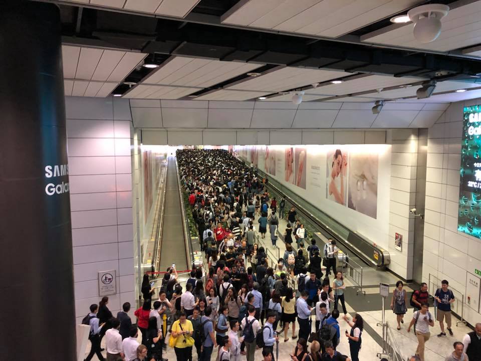 Tens of commuters at Hong Kong station towards Central, which commuters on social media say is now so packed that it's practically closed. photo via Facebook/Henry Cheung.