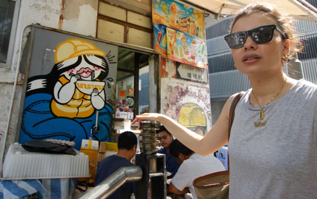 Artist Catherine Grossrieder with the noodle-slurping Jeliboo on Ladder Street. Pic: Coconuts HK