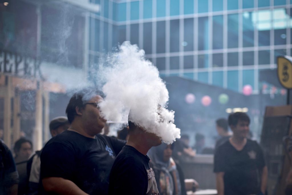Visitors puff on their e-cigarettes during the 2018 Jakarta Vape Fest in South Jakarta, Indonesia, on May 6, 2018. Photo: Reynold Sumayku