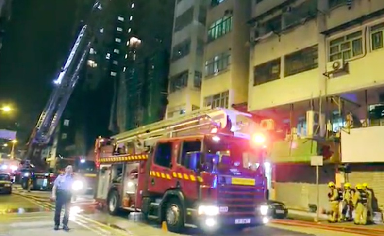 Emergency services gathered outside an address on Tai Nan Street where a grisly murder-suicide and arson attack took place. Screengrab via Apple Daily video.