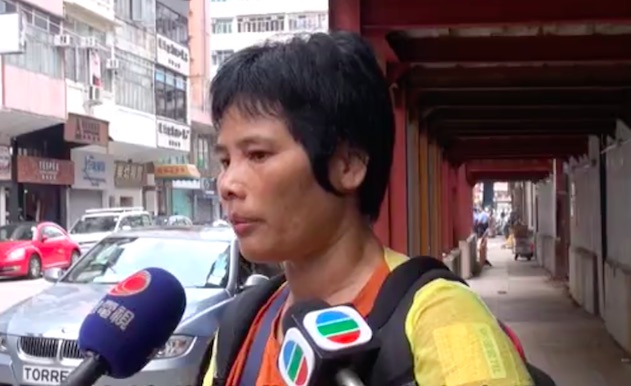 Zhou Guanyu's wife speaking to reporters the day after her husband was found dead in a murder suicide arson incident in Sham Shui Po. Screengrab via Apple Daily