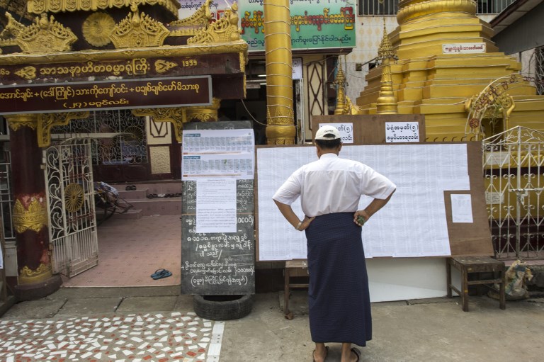 A voter checks the voters’ list at a polling station in Yangon on November 3, 2018. – Myanmar voters cast their ballots in a small but key by-election on November 3, 2018, a rare local test of support for embattled leader Aung San Suu Kyi’s National League for Democracy (NLD) party more than halfway through her time in office. (Photo by Ye Aung Thu / AFP)