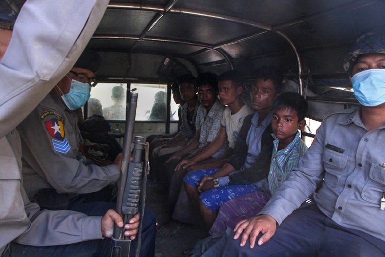 Police escort a group of Rohingya men and boy in Kyauktan township south of Yangon on November 16, 2018 after their boat washed ashore. – A boatload of Rohingya who left a camp in Myanmar’s Rakhine state, arrived in Thante village in Kyauktan township on November 16 after they attempted to sail to Malaysia. (Photo by Myo Kyaw SOE / AFP)