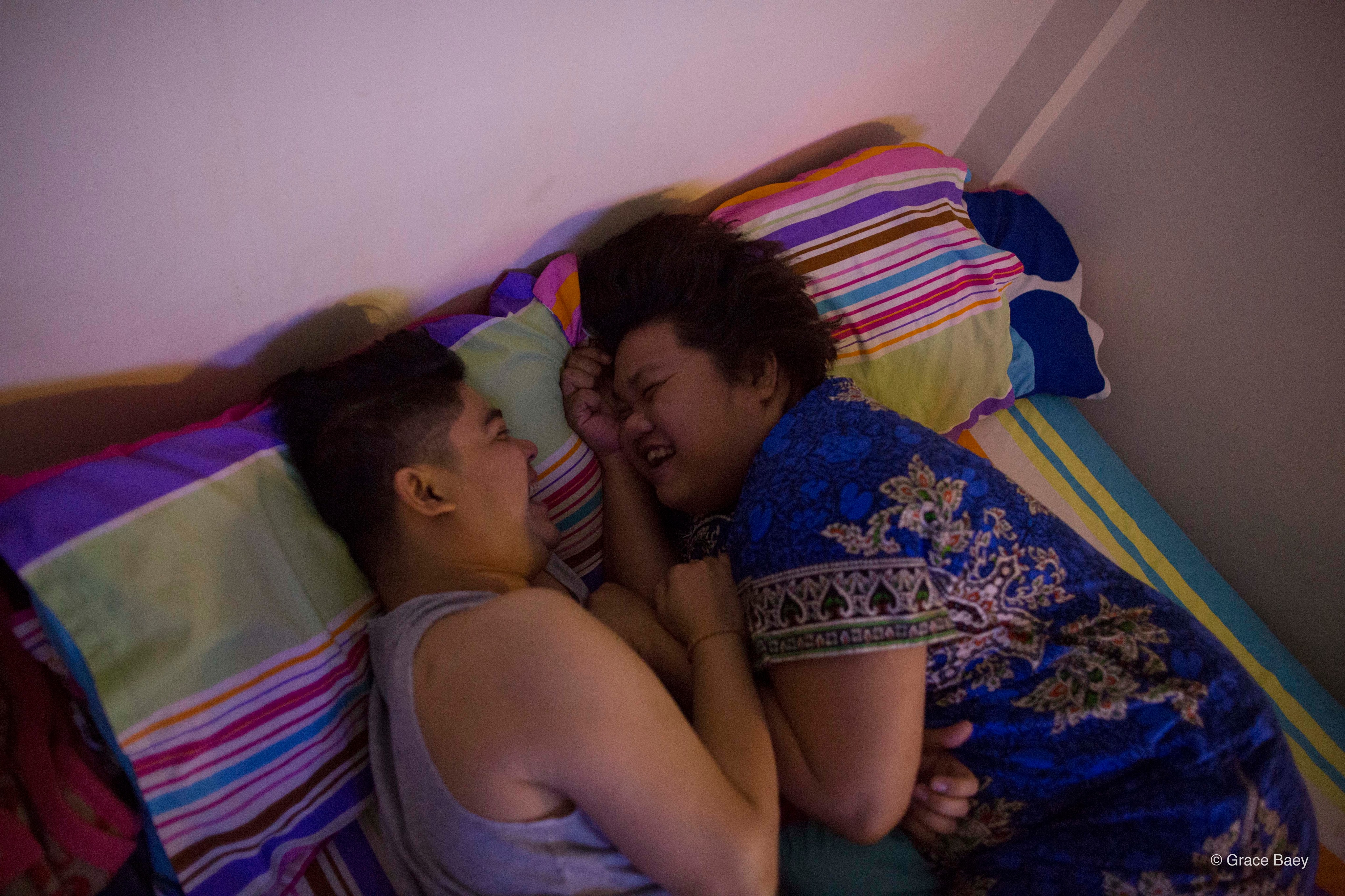 Yaya enjoys a light-hearted moment with her partner, Kaw San, in their shared apartment. Yaya and Kaw San have been living together for the past six years. Kaw San also cared for Yaya’s mother when she was ill and eventually passed on. Photo: Grace Baey