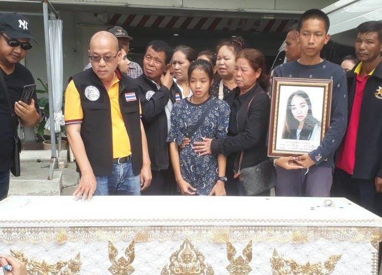 The 12-year-old daughter with family and police beside mother’s casket. Photo: Facebook/ Vichai Sookkratoke