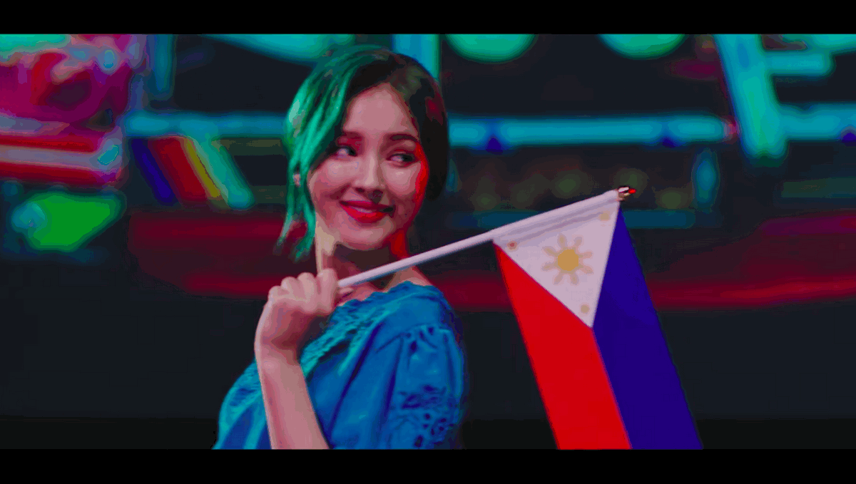 Nancy McDonnie proudly holds the Philippine flag. Screenshot from Baam’s music video.