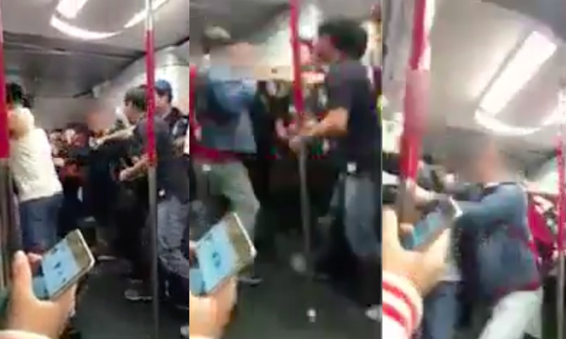 A fight erupts in the MTR after one man reportedly coughed on another commuter. Screengrab via Facebook video.