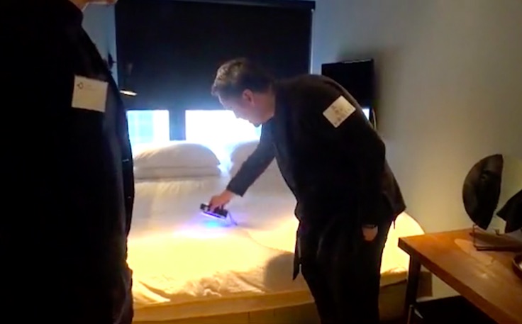 One of Up-otel’s investors demonstrating how clean the sheets are at the hotel. Screengrab via Apple Daily video.