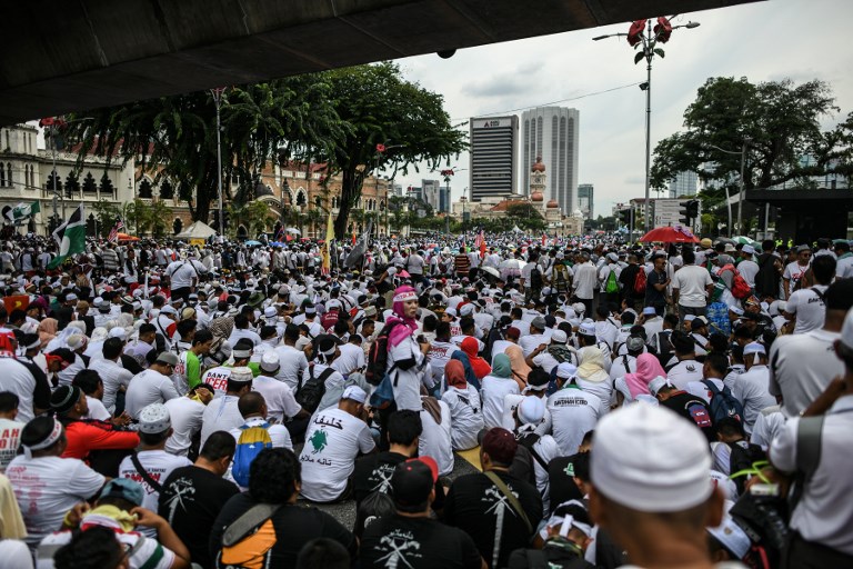 Protesters gather during a rally organised by Muslim politicians against the signing of the UN anti-discrimination convention (ICERD) at Merdeka Square in Kuala Lumpur on December 8, 2018. (Photo by Mohd RASFAN / AFP)