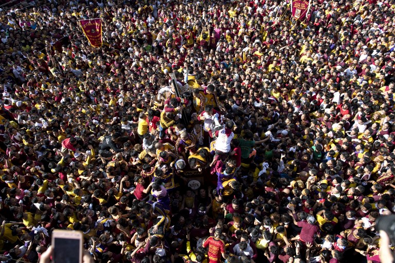 Catholic devotees transport the carriage of the Black Nazarene statue through the streets during the annual religious procession in honor of the Black Nazarene in Manila on January 9, 2019. (Photo: Noel Celis, AFP)