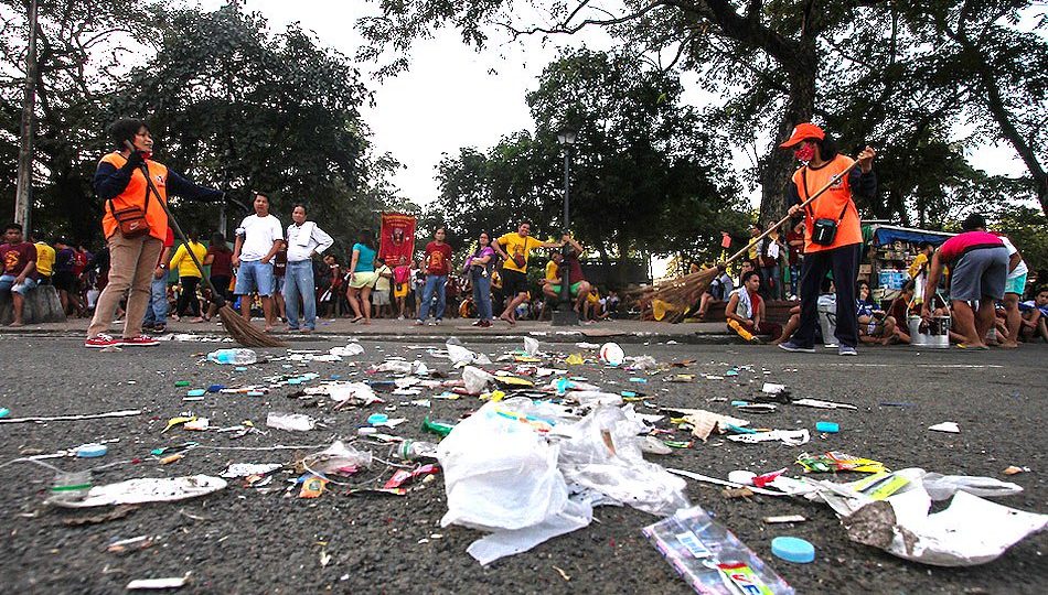 Cleaners sweep the trash left by the Black Nazarene’s devotees at the Rizal Park. Photo: Jhun Dantes/ABS-CBN News  