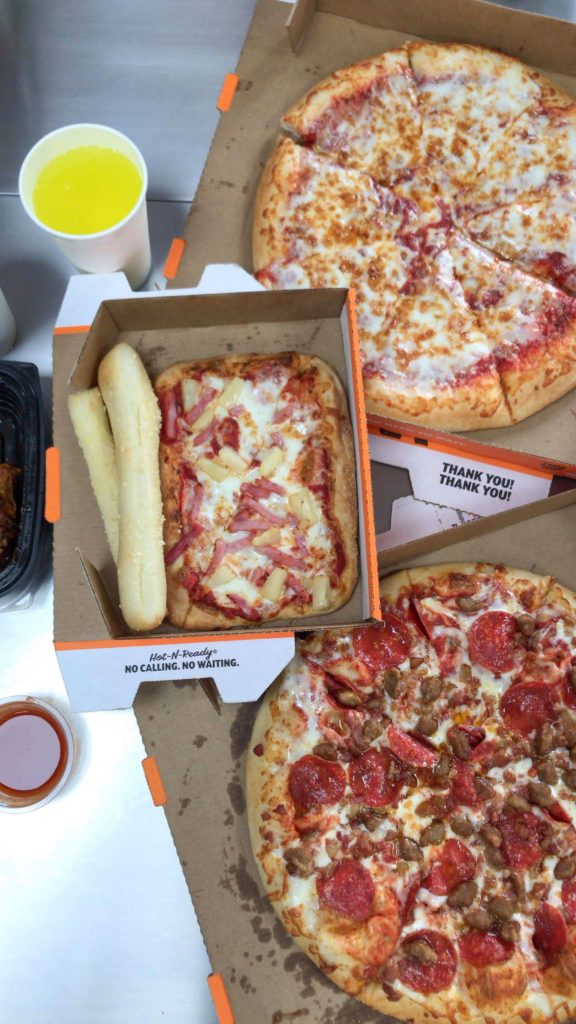 Photo (U-D): Little Caesars' cheese pizza, the Single Serve Hula Hawaiian Pizza, Crazy Bread, and the 3 Meat Pizza, captured by Kaka Corral