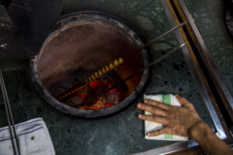 Shish cooks in a tandoor at Hong Kong’s New Punjab Club, the world’s first Michelin-starred Pakistani restaurant. Photo via AFP.