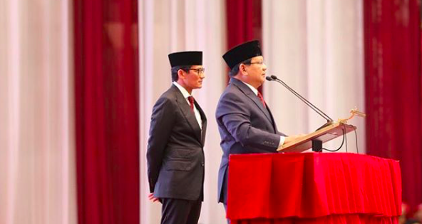 Indonesian presidential candidate Prabowo Subianto making a speech during a televised address, with his running mate Sandiaga Uno standing behind him. Photo: Instagram/@prabowo