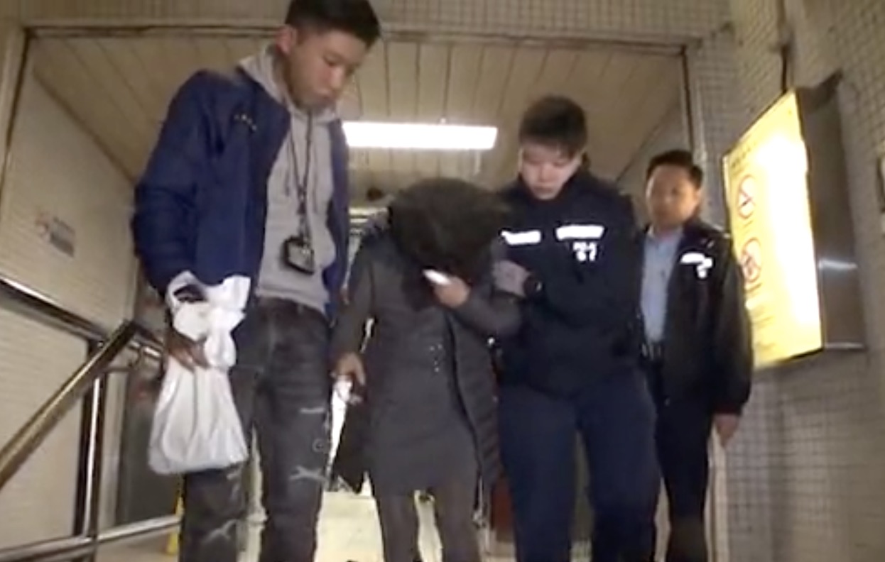 41-year-old Ming Yongfang being arrested after stabbing her husband’s mistress. She was sentenced to two years in jail at the District Court on January 30. Screengrab via Apple Daily video.