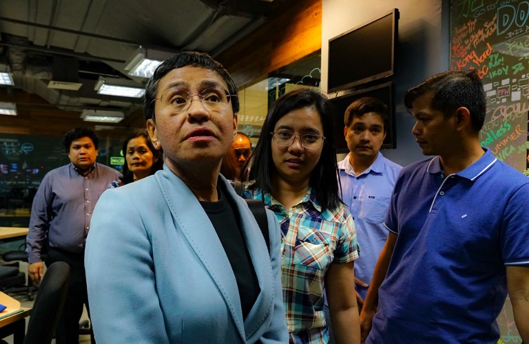 Philippine journalist Maria Ressa leaves her office after she was arrested in Manila on February 13, 2019. (Photo: Maria Tan, AFP)