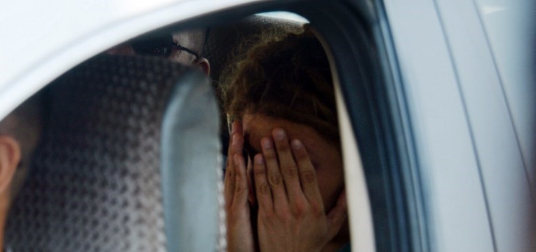 This photo taken on February 22, 2019 shows detained French tourist Arthur Desclaux covering his face while leaving in a police car after facing trial in Naypyidaw. – A French tourist has been sentenced to one month in prison with hard labour for attempting to fly a drone near Myanmar’s parliament in the capital Naypyidaw, a court official said February 27. (Photo by Sai Aung MAIN / AFP)