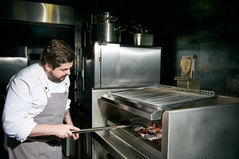 Chef Aitor prepping the Basque Grill oven. Photo: Basque Kitchen by Aitor