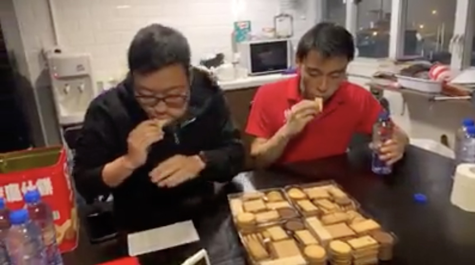 Thousands tune in to watch two men eat an entire tin of Garden Bakery cookies. Screengrab via Facebook video/100most.