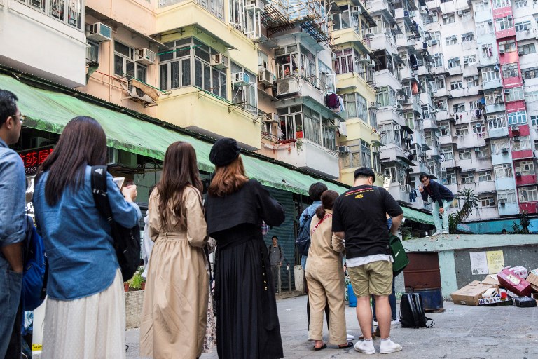 Instagrammers line up to take a photo at the optimum spot in front of a famous Hong Kong housing estate. Photo via AFP.