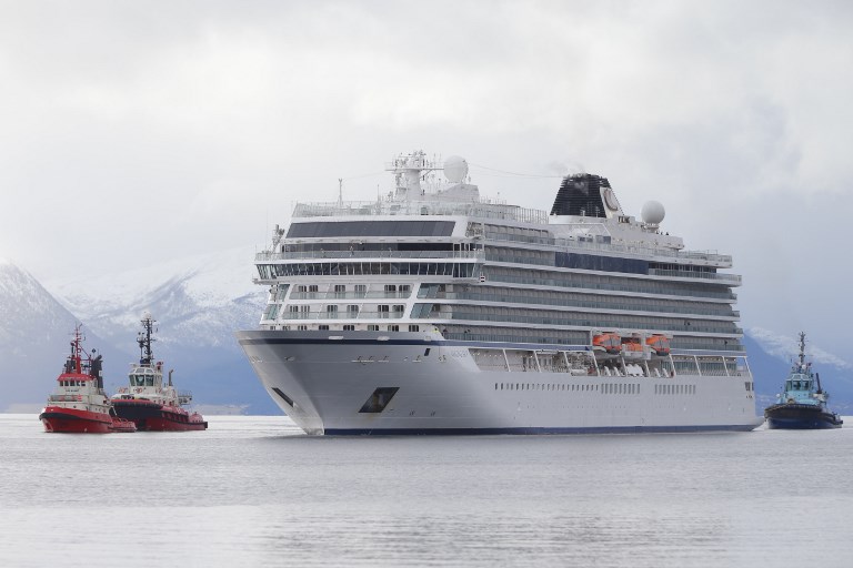 The cruise ship Viking Sky which ran into trouble in stormy seas off Norway arrived at the port of Molde on March 24 while escorted by tugboats. Photo: Svein Ove EKORNESVAAG / NTB scanpix / AFP) / Norway OUT