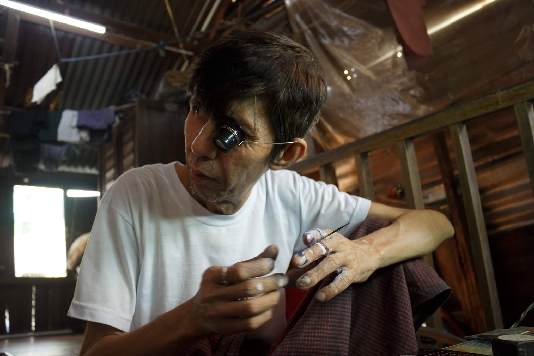 Ko Lu Maw working on a watch face. Photo: Nay Paing/Coconuts Media