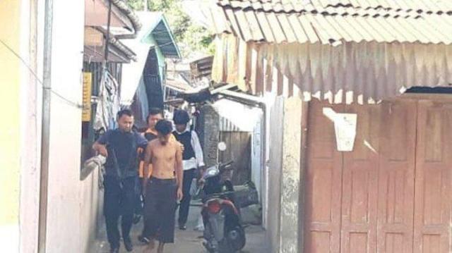 Abu Hamzah (shirtless) being escorted by police during his arrest on March 12, 2019. Photo: Twitter