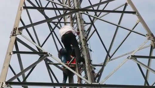 Purwakarta Deputy Regent Haji Maming (white shirt) climbing a cell phone tower to help talk a man out of committing suicide on March 12, 2019. Photo: Instagram/@haji_maming