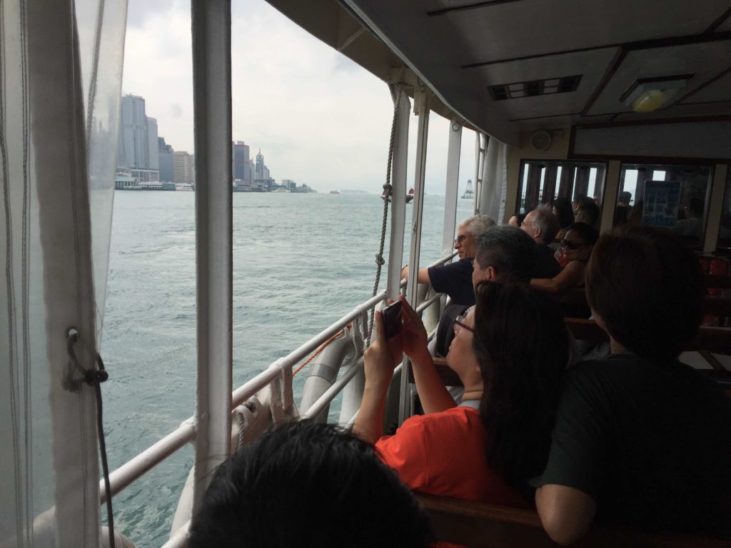 Ferry passengers take in the Kaws floating exhibition in Victoria Harbor today. Photo by Stuart White.
