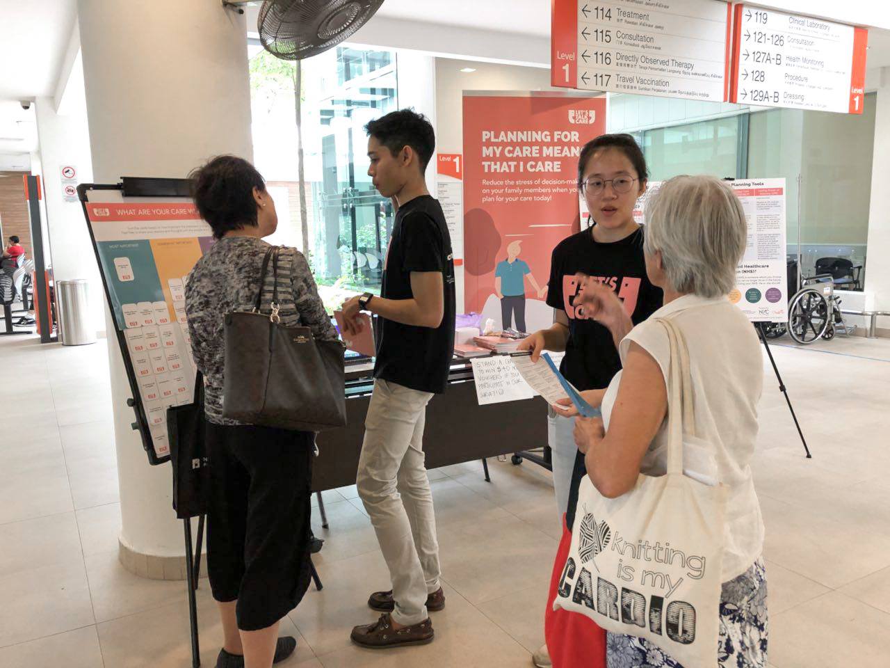 The students speaking to elderly individuals at polyclinics in Singapore (Photo: Let's Talk Care / Facebook)