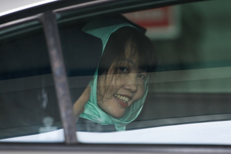 Vietnamese national Doan Thi Huong (R) smiles as she is escorted by Malaysian police out of the High Court in Shah Alam on April 1, 2019. (Photo by Mohd RASFAN / AFP)