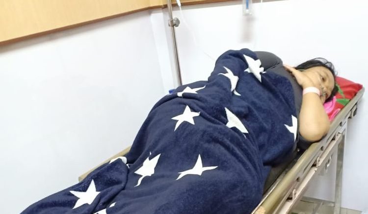 A 26-year-old election volunteer named Andriana lying on a hospital bed after she prematurely gave birth to her baby. She says she was forced to deliver her baby in the fifth month of her pregnancy due to exhaustion from volunteering during Indonesia’s April 17 election. Photo: West Nusa Tenggara General Election Commission
