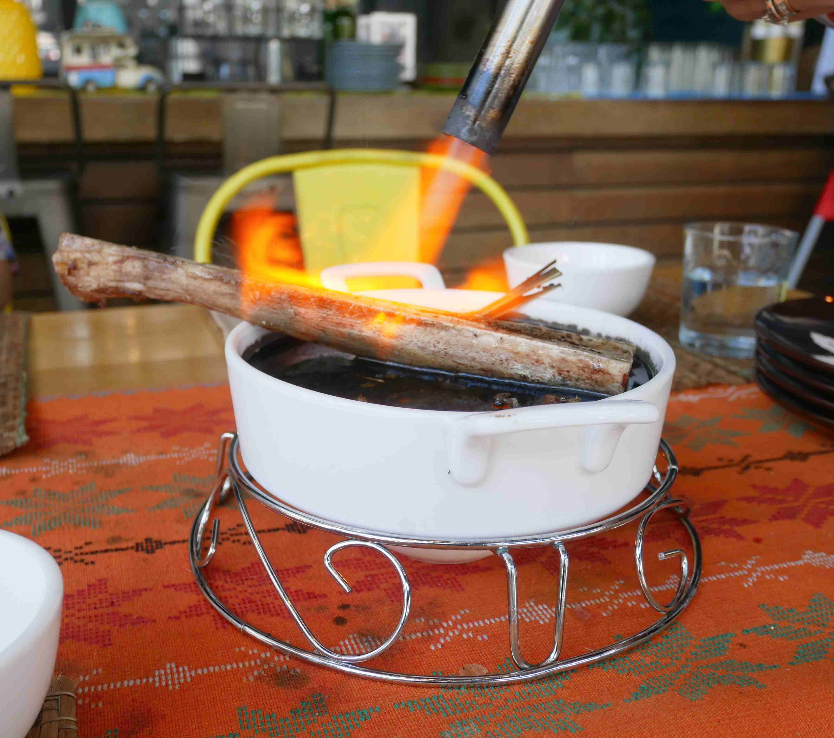 Bone marrow being torched before it was served. Photo: Rachel Malaguit