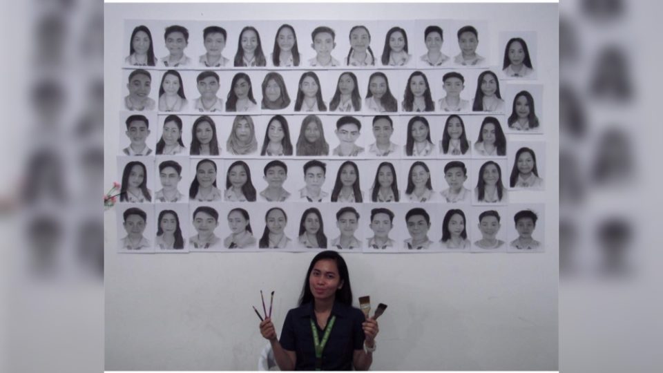 Teacher Mailyn Akoy with the portraits of her students. Photo: Akoy’s FB