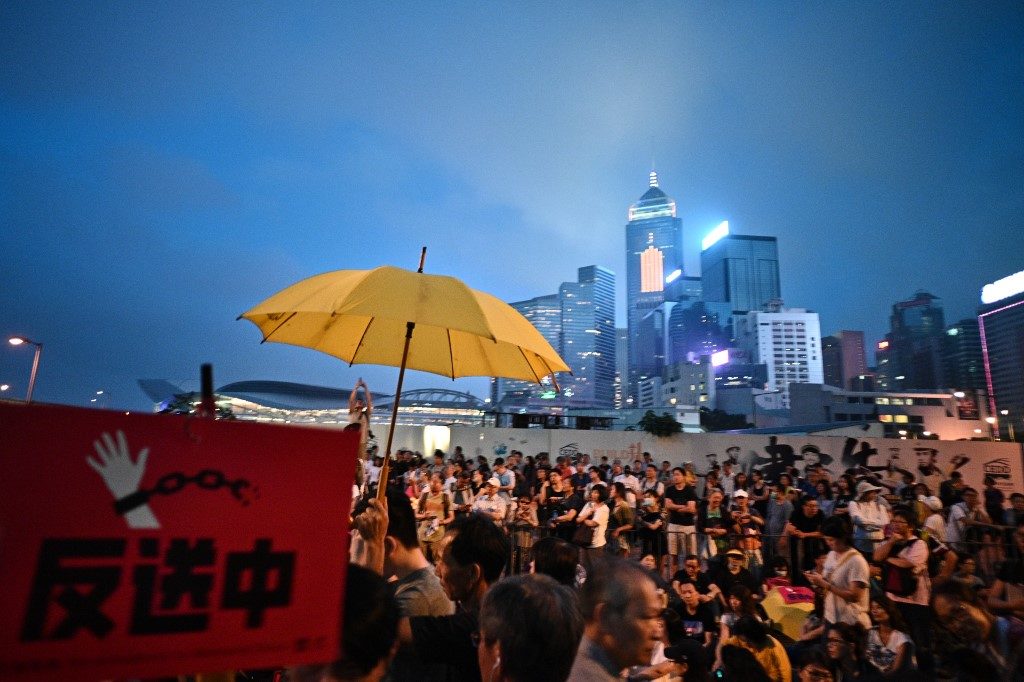 A yellow umbrella, the symbol of the 2014 pro-democracy demonstrations that brought Hong Kong to a standstill, is seen at a protest against extradition law amendments on Sunday. Photo via AFP.