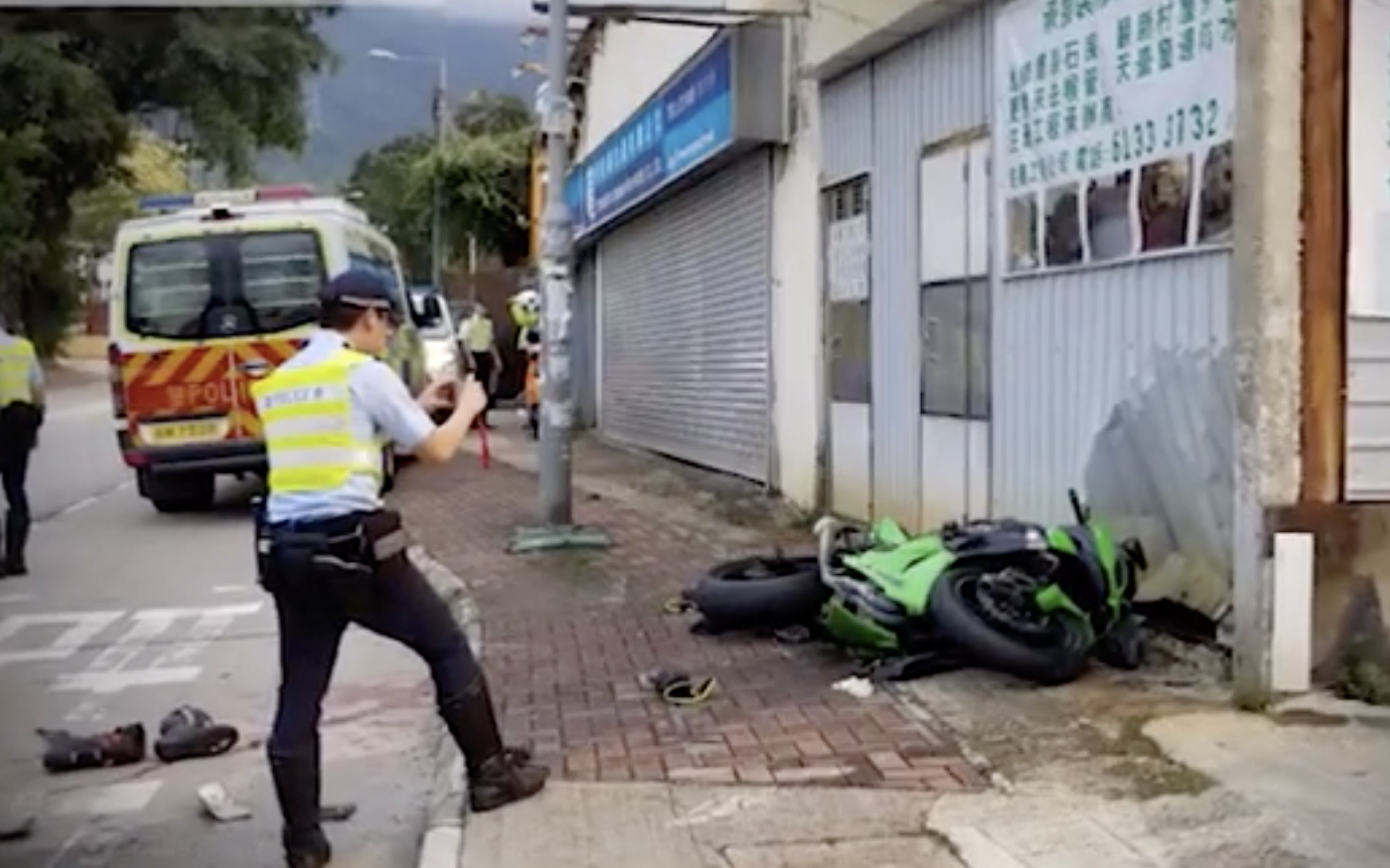 Police at the site of a motorcycle crash. Screengrab via Apple Daily video.