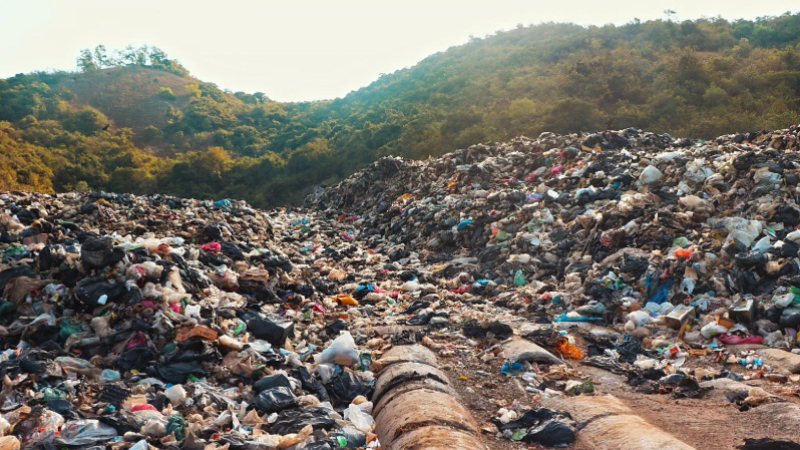 Garbage piled in the Koh Lan landfill matches the sloping hills behind. Photo: Ajith Srinivasan / Coconuts Media