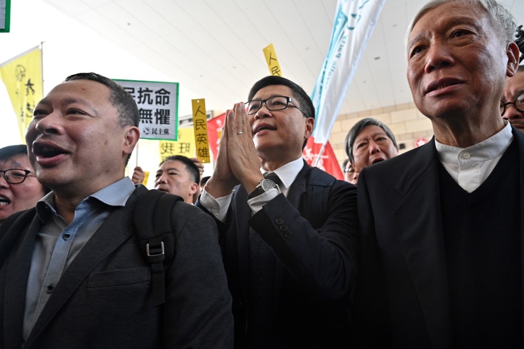 Law professor Benny Tai (left), along with Baptist minister Chu Yiu-ming (right) and sociology professor Chan Kin-man (center) enter the West Kowloon Magistrates Court in April. Tai has said in letters from prison that Hongkongers are beginning to question the viability of nonviolence. Photo via AFP.