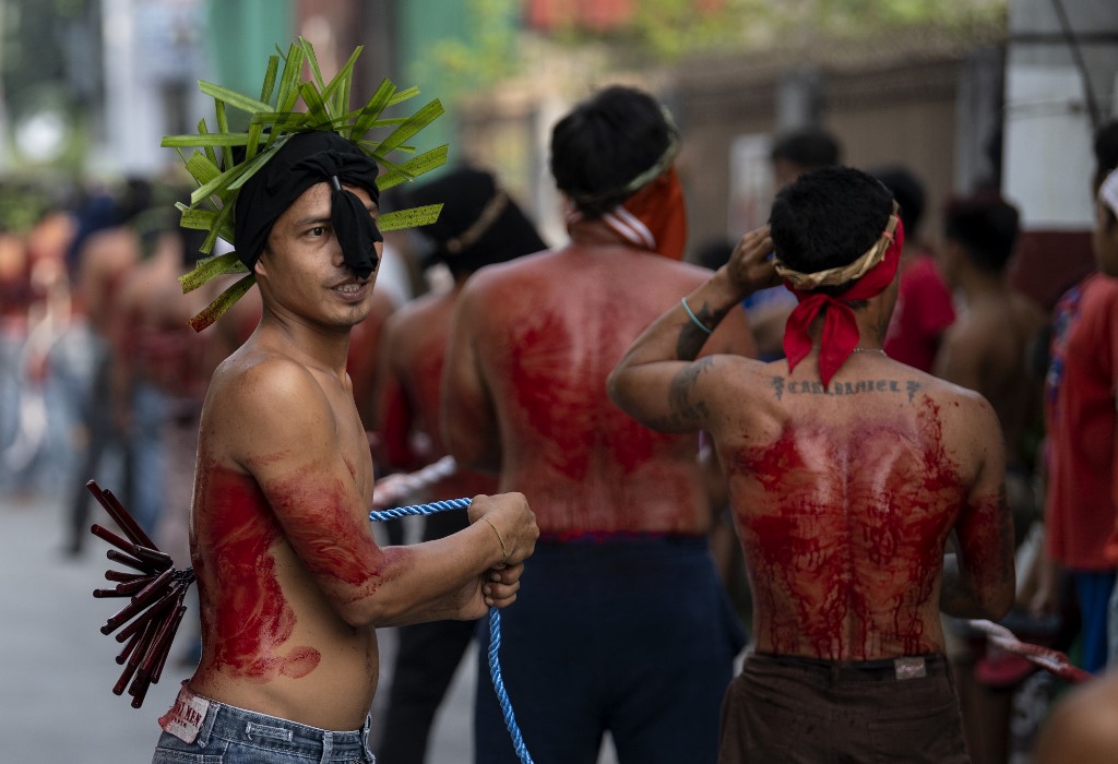 Christian devotees whip their backs with bamboo strips on a street in San Juan, Pampanga on April 19, 2019, during the reenactment of the crucifixion of Jesus Christ on Good Friday. Noel Celis / AFP